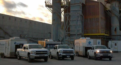 Three Trucks Lined Up with Trailers